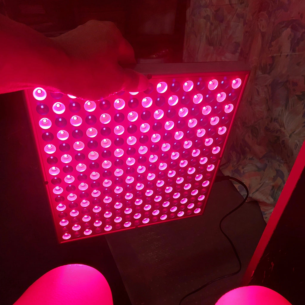 LED light panel emitting a pinkish-red glow
